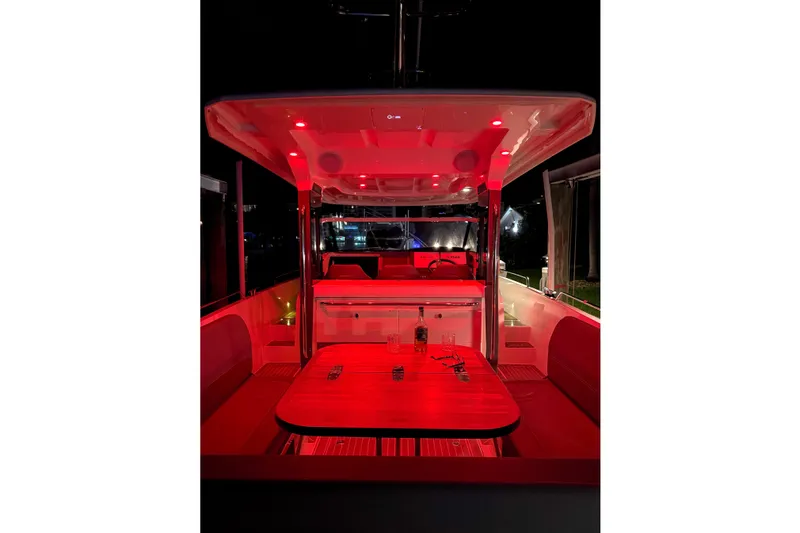  Yacht Photos Pics 2022 Nimbus T11 boat interior with red ambient lighting at night.