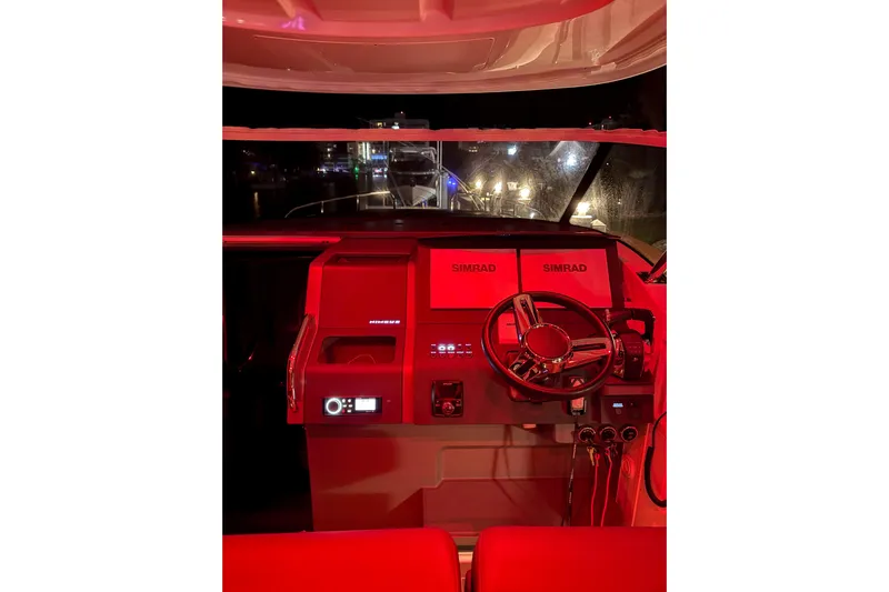  Yacht Photos Pics Red-lit helm of 2022 Nimbus T11 boat with Simrad navigation system.