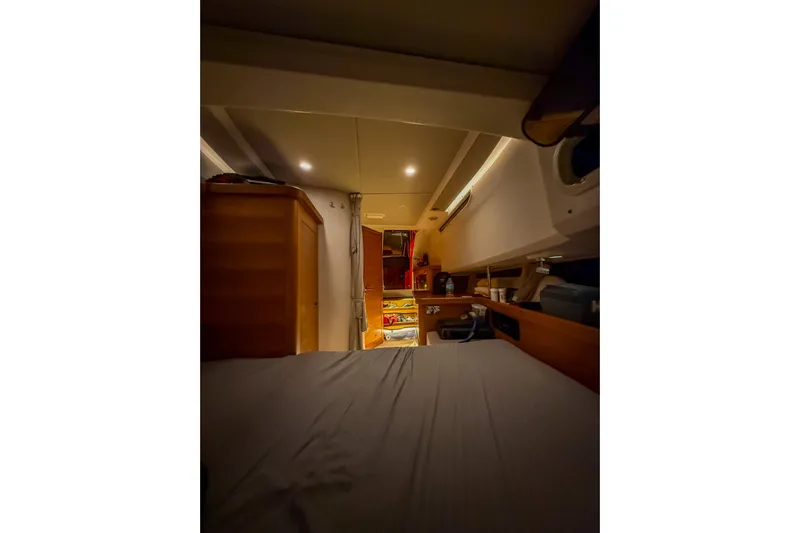  Yacht Photos Pics Cozy interior cabin of 2022 Nimbus T11 boat with bed and storage.