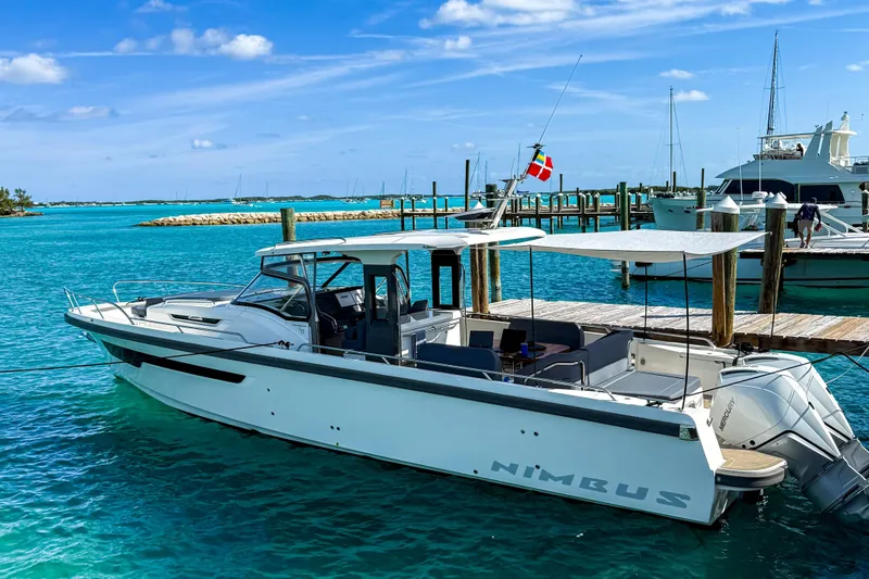  Yacht Photos Pics 2022 Nimbus T11 boat docked in clear turquoise water under a sunny sky.
