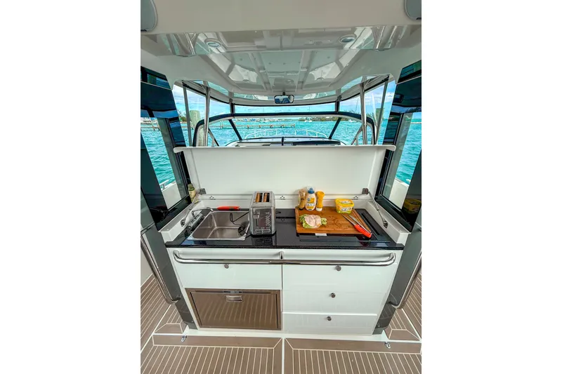  Yacht Photos Pics Outdoor kitchen on 2022 Nimbus T11 boat with sink, toaster, and cutting board.
