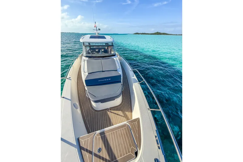  Yacht Photos Pics Nimbus T11 2022 boat cruising on clear turquoise waters under a blue sky.
