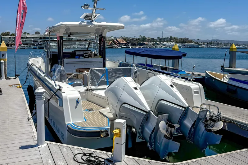  Yacht Photos Pics Nimbus T11 2022 boat docked with dual engines, clear sky, and marina view.
