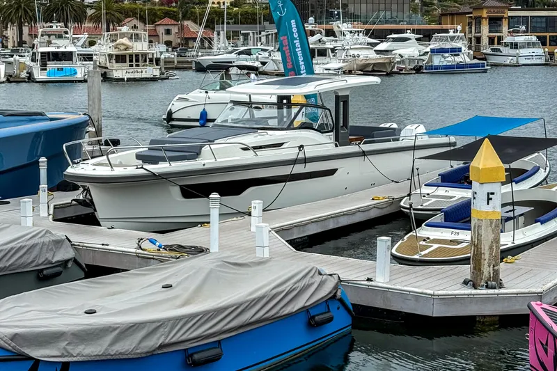  Yacht Photos Pics Nimbus T11 2022 boat docked at a marina with other vessels in the background.