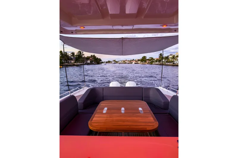  Yacht Photos Pics Nimbus T11 2022 boat interior with wooden table, overlooking serene waterway.