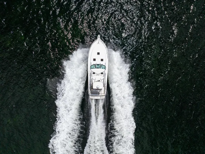 Mutiny Yacht Photos Pics Aerial view of a 2004 Tiara Yachts 4200 Open cruising on water.