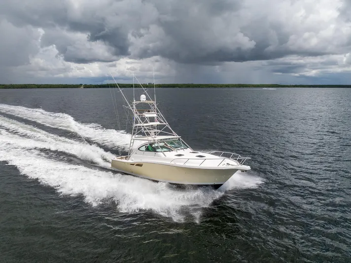 Mutiny Yacht Photos Pics 2004 Tiara Yachts 4200 Open cruising on open water under cloudy skies.