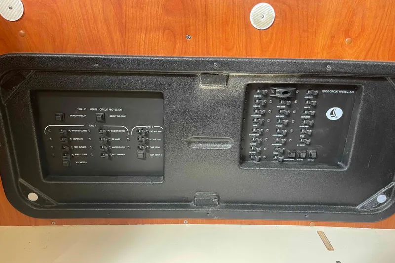 Snail'n Yacht Photos Pics Electrical panel of a 2010 Hunter 45 Center Cockpit sailboat, featuring circuit protection switches.