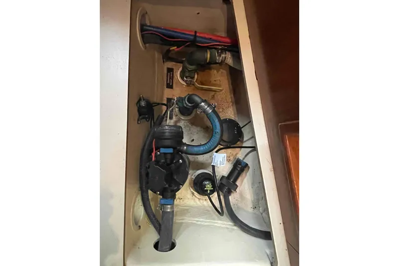Snail'n Yacht Photos Pics Bilge area of 2010 Hunter 45 Center Cockpit sailboat with hoses and fittings.