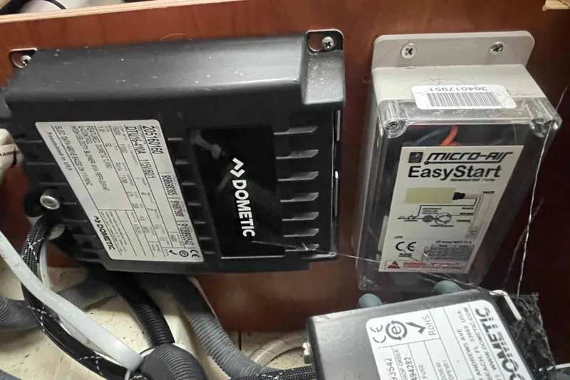 Snail'n Yacht Photos Pics Electrical components in a 2010 Hunter 45 Center Cockpit, featuring Dometic and Micro-Air EasyStart devices.