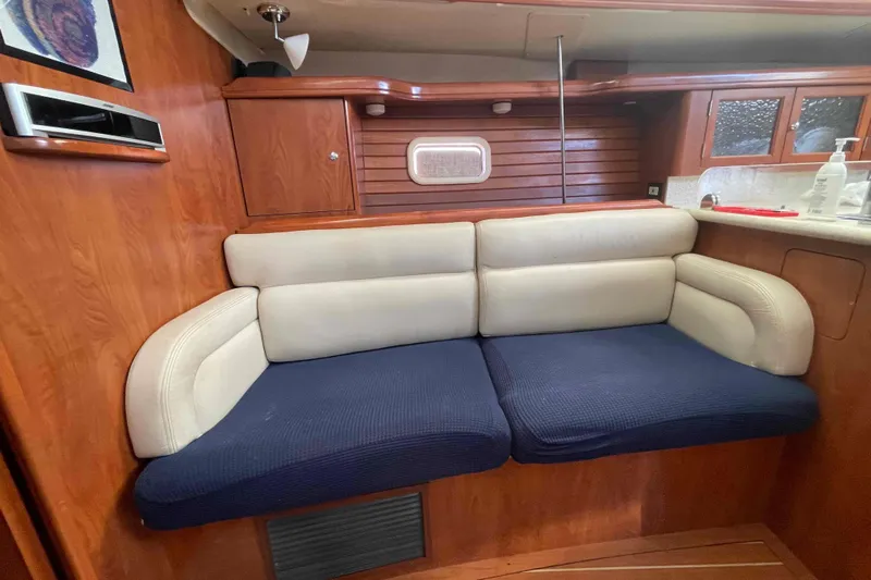 Snail'n Yacht Photos Pics Interior of 2010 Hunter 45 Center Cockpit yacht with cozy seating and wooden cabinetry.