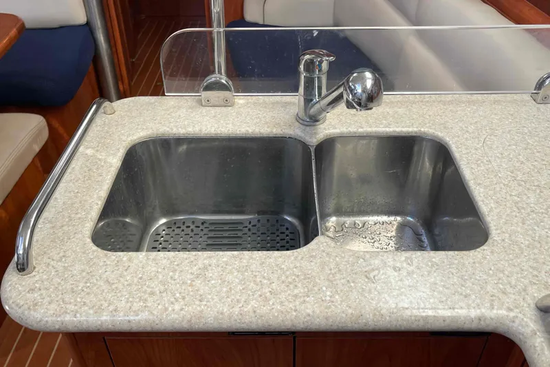 Snail'n Yacht Photos Pics Galley sink in 2010 Hunter 45 Center Cockpit yacht, featuring dual basins and faucet.