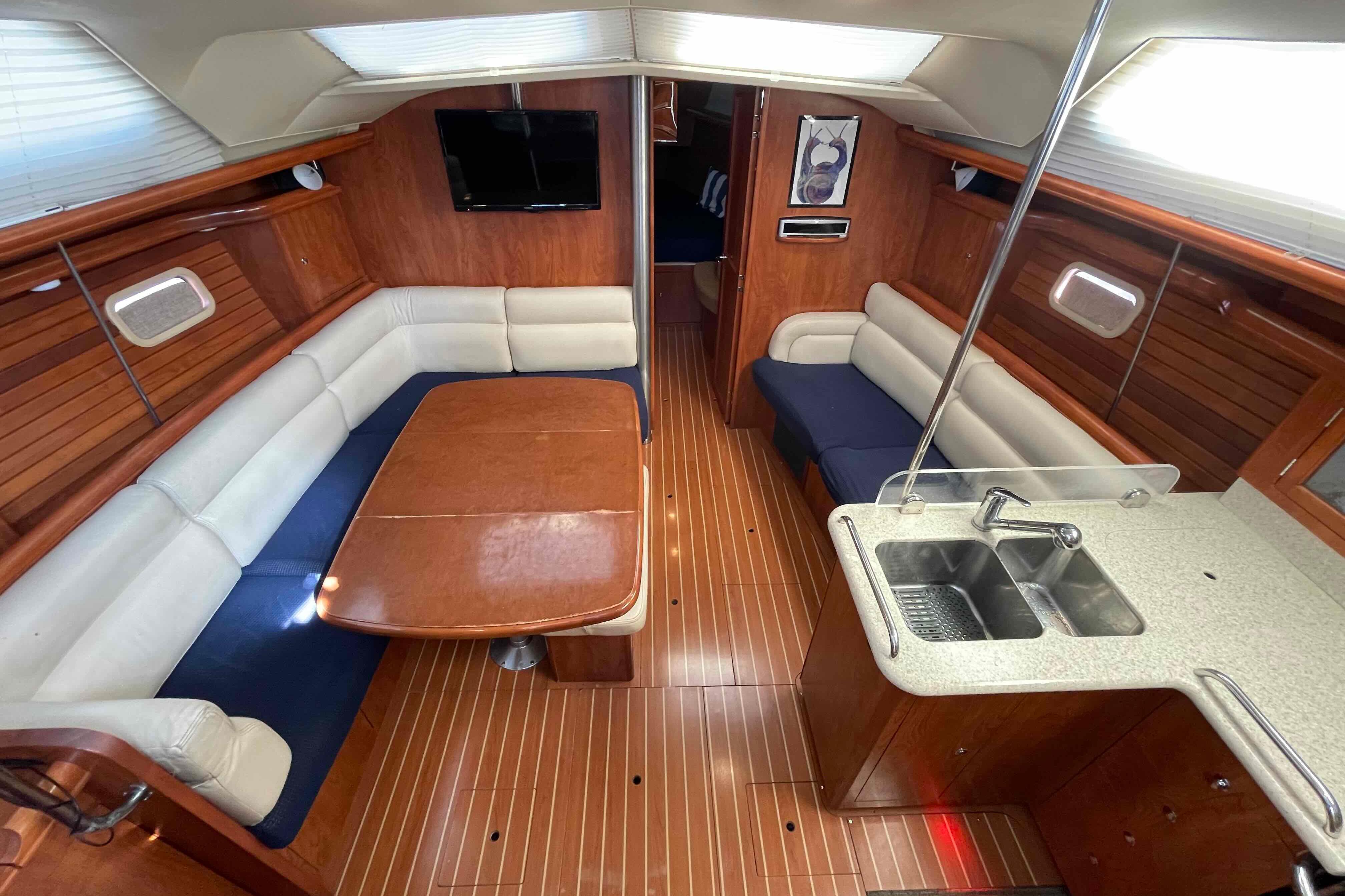 Luxurious interior of 2010 Hunter 45 Center Cockpit yacht with wood finish and modern amenities.