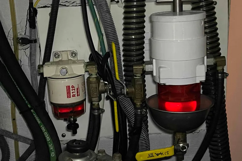 Snail'n Yacht Photos Pics Engine compartment of 2010 Hunter 45 Center Cockpit with fuel filters and hoses.