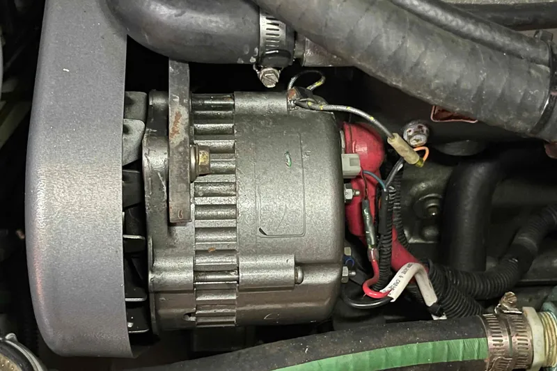 Snail'n Yacht Photos Pics Engine component of a 2010 Hunter 45 Center Cockpit sailboat, showing alternator and wiring.