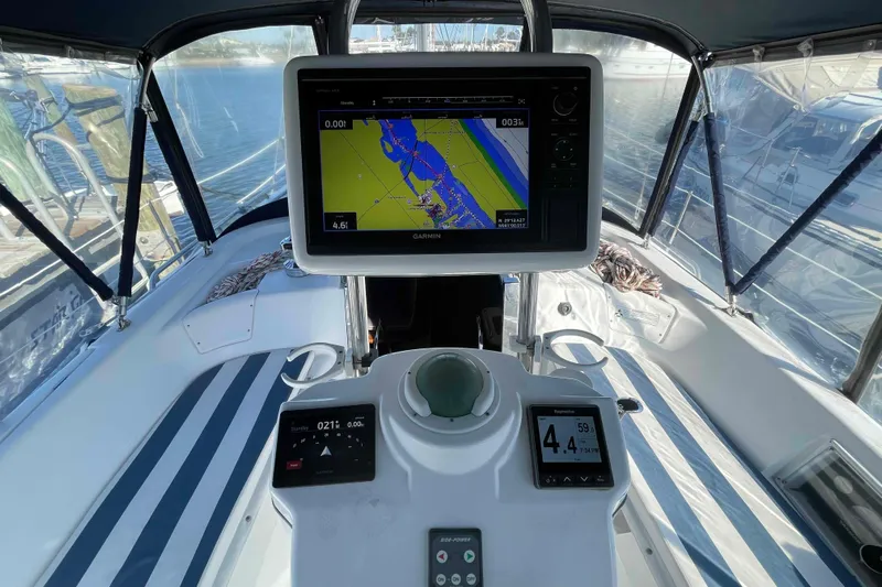 Snail'n Yacht Photos Pics Cockpit of 2010 Hunter 45 Center Cockpit sailboat with navigation equipment and striped seating.