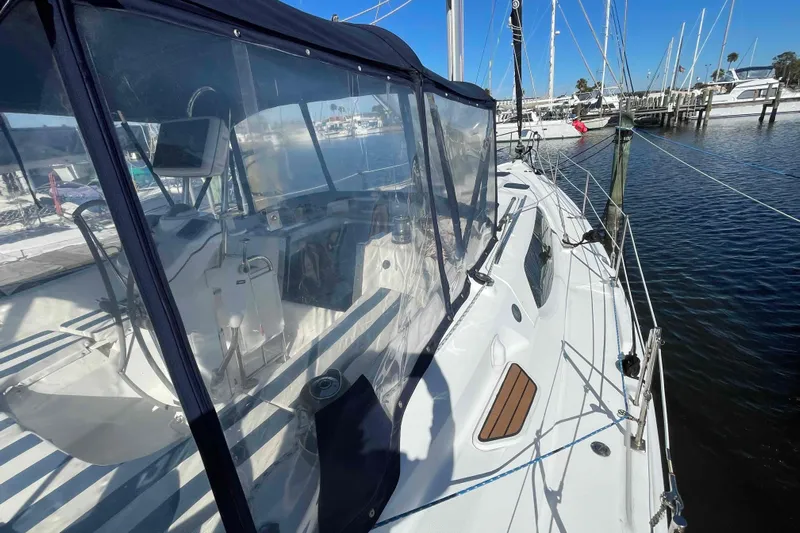 Snail'n Yacht Photos Pics 2010 Hunter 45 Center Cockpit sailboat docked at marina, clear canopy visible.