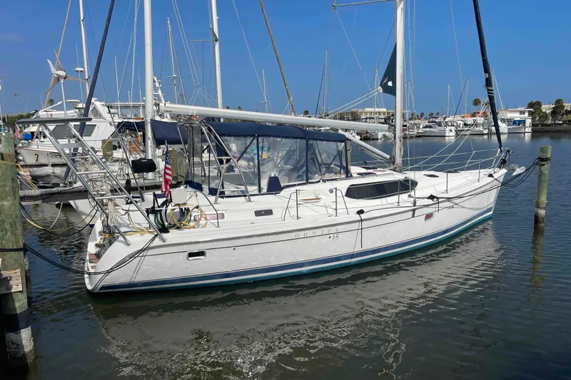 Snail'n Yacht Photos Pics 2010 Hunter 45 Center Cockpit sailboat docked in a marina under clear blue skies.