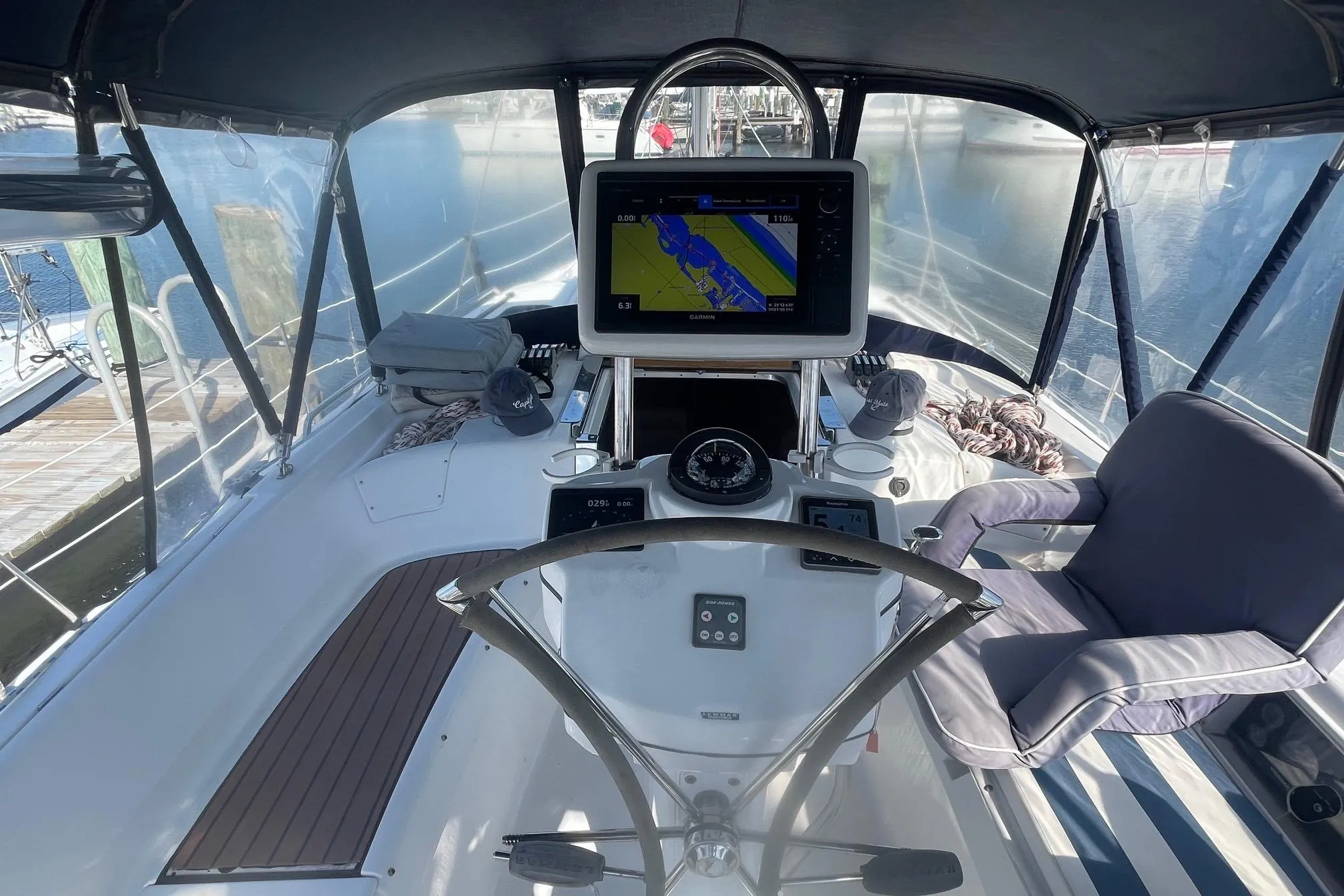 2010 Hunter 45 Center Cockpit with navigation system and comfortable seating in a marina setting.