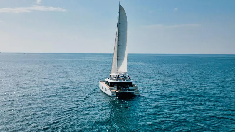 Feel The Blue Yacht Photos Pics Sailing Sunreef 60 catamaran on open sea, 2018 model, under clear blue sky.