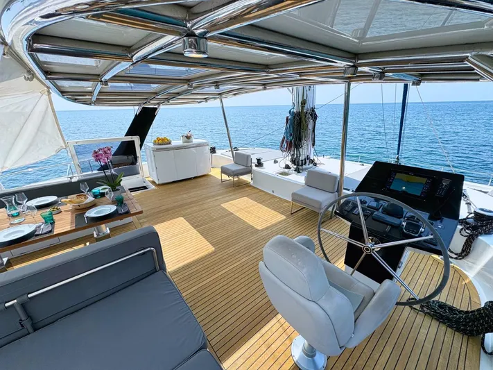 Feel The Blue Yacht Photos Pics Luxurious Sunreef 60 yacht deck with elegant seating, dining area, and ocean view, 2018 model.