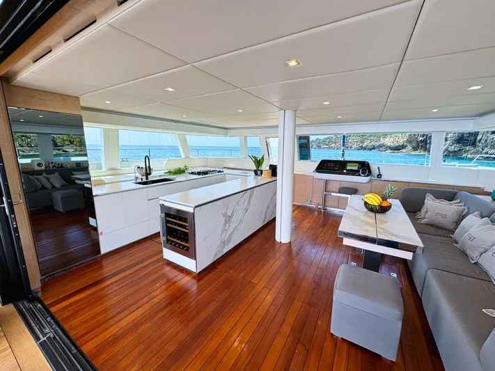 Feel The Blue Yacht Photos Pics Luxurious interior of 2018 Sunreef 60 yacht with modern kitchen and ocean view.