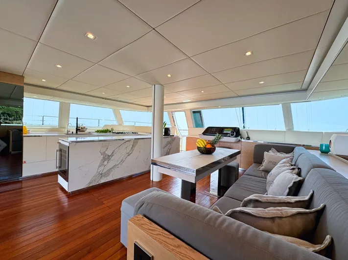 Feel The Blue Yacht Photos Pics Luxurious interior of 2018 Sunreef 60 yacht with modern kitchen and comfortable seating area.