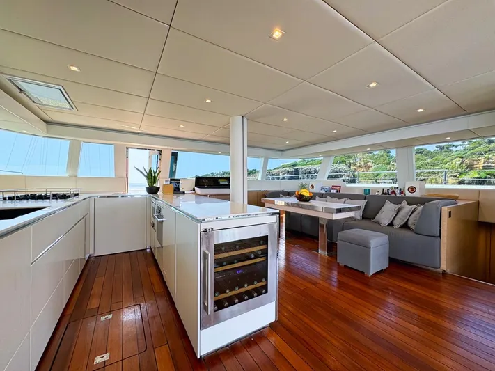 Feel The Blue Yacht Photos Pics Luxurious interior of 2018 Sunreef 60 yacht with modern kitchen and seating area.