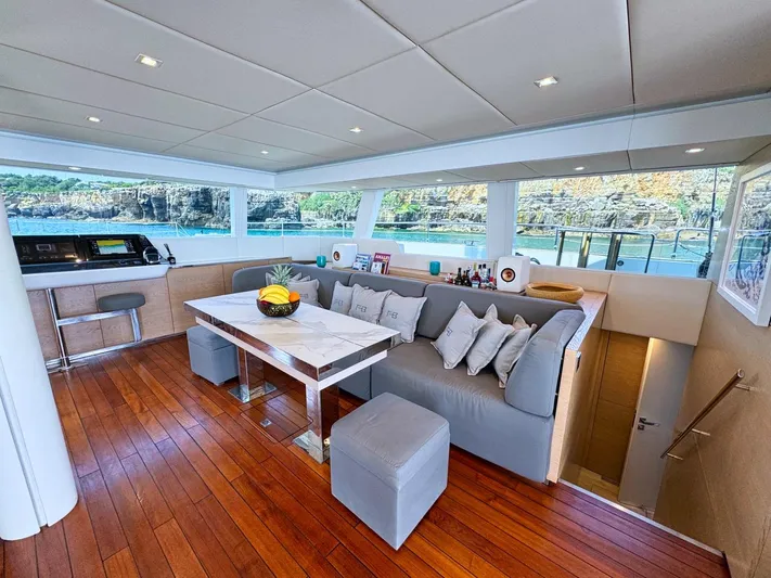 Feel The Blue Yacht Photos Pics Luxurious interior of 2018 Sunreef 60 yacht with elegant seating and dining area.