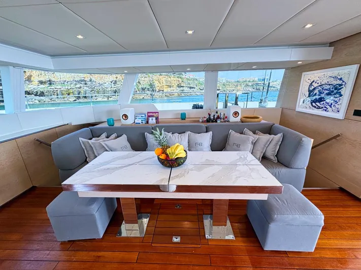 Feel The Blue Yacht Photos Pics Luxurious interior of 2018 Sunreef 60 yacht with elegant dining area and scenic views.