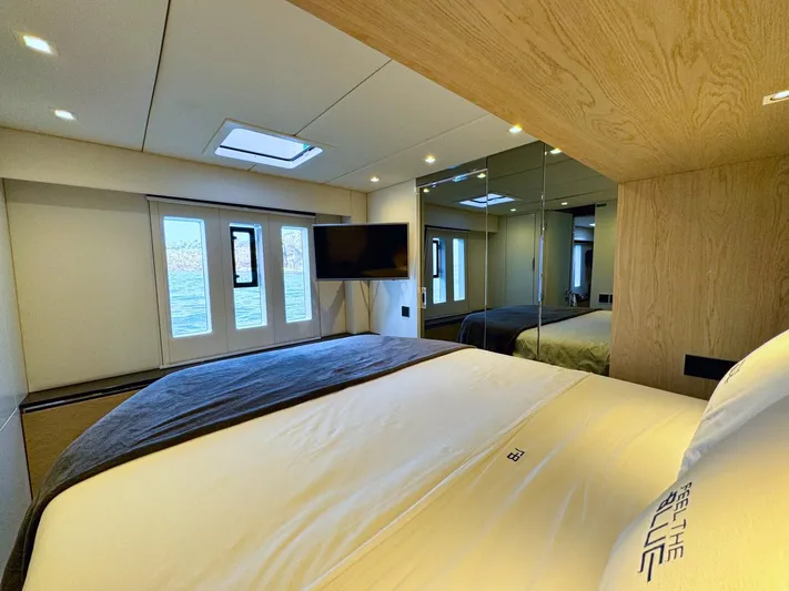 Feel The Blue Yacht Photos Pics Luxurious bedroom interior of 2018 Sunreef 60 yacht with modern design and large windows.