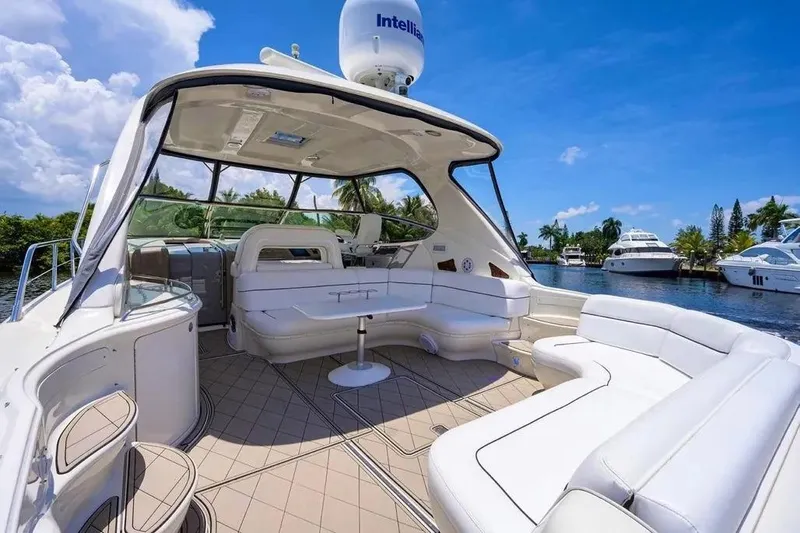 Still The One Yacht Photos Pics Luxurious 2004 Sea Ray 550 Sundancer yacht interior with white seating and scenic waterway view.