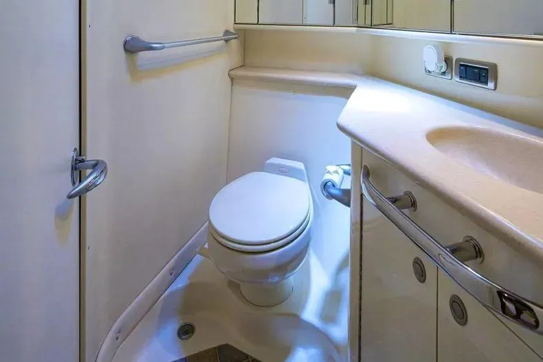 Still The One Yacht Photos Pics 2004 Sea Ray 550 Sundancer yacht bathroom with toilet and sink, featuring modern fixtures.