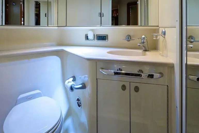 Still The One Yacht Photos Pics Luxurious bathroom in 2004 Sea Ray 550 Sundancer yacht, featuring modern fixtures and cabinetry.