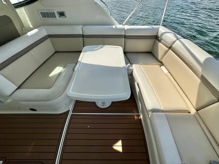  Yacht Photos Pics Luxurious seating area on 2013 Sea Ray 410 Sundancer yacht with elegant table and wood flooring.