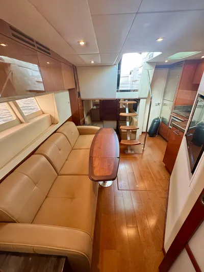  Yacht Photos Pics Luxurious interior of 2013 Sea Ray 410 Sundancer yacht with leather seating and wooden flooring.
