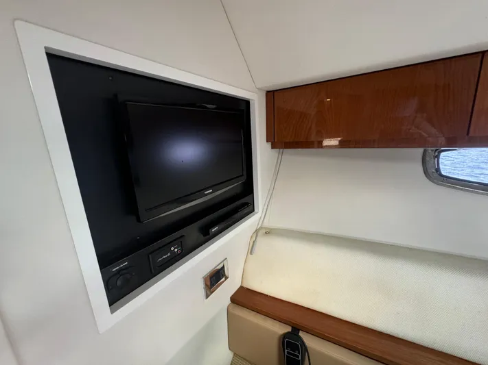  Yacht Photos Pics Interior of 2013 Sea Ray 410 Sundancer with TV and wooden cabinet.