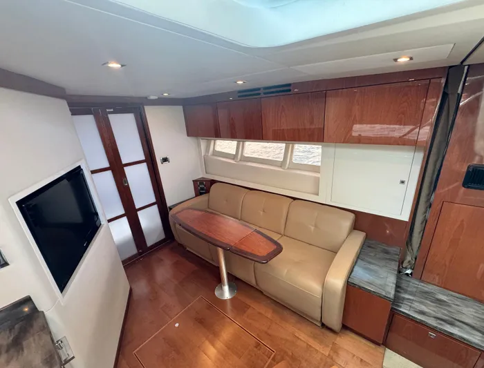 Yacht Photos Pics Luxurious interior of 2013 Sea Ray 410 Sundancer yacht with leather seating and wood finishes.