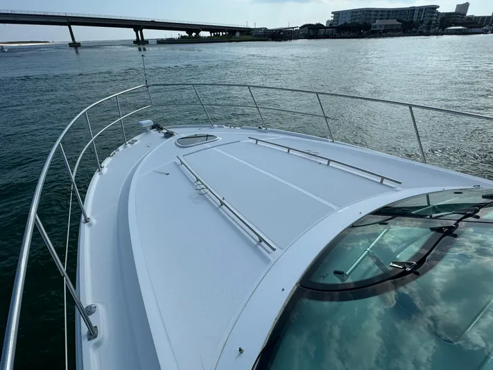  Yacht Photos Pics Sea Ray 410 Sundancer 2013 yacht on water near a bridge and cityscape.