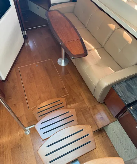  Yacht Photos Pics Interior of 2013 Sea Ray 410 Sundancer with wooden flooring and beige sofa.