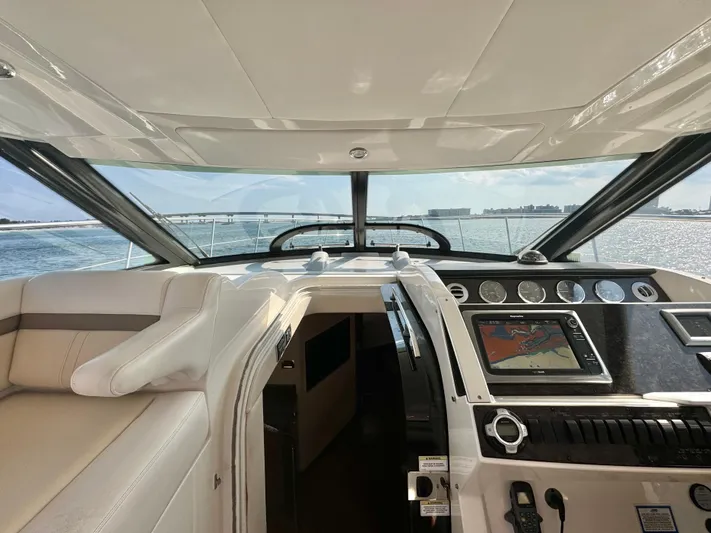  Yacht Photos Pics Interior view of 2013 Sea Ray 410 Sundancer yacht cockpit with navigation system.