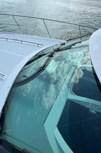  Yacht Photos Pics 2013 Sea Ray 410 Sundancer yacht with reflective glass on calm water.