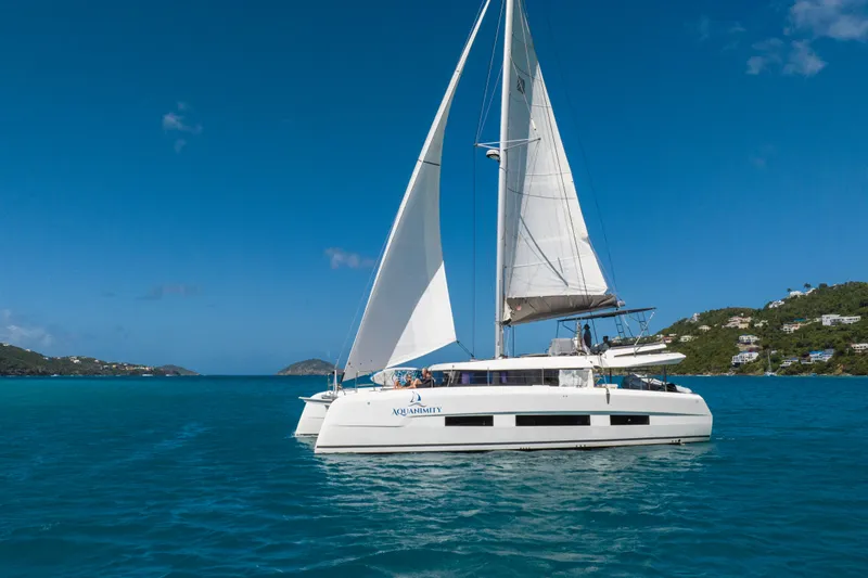 Aquanimity Yacht Photos Pics Sailing catamaran Dufour 48, 2021 model, cruising in clear blue waters.