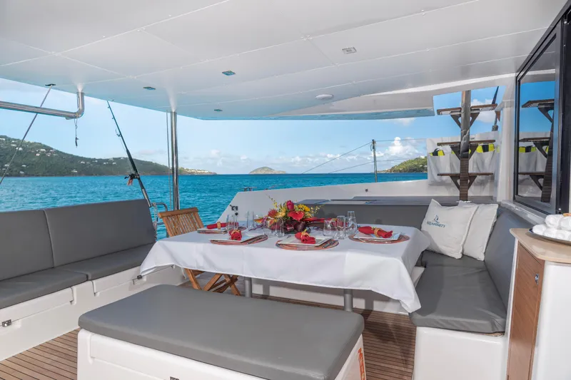 Aquanimity Yacht Photos Pics Luxurious dining area on a 2021 Dufour 48 yacht with ocean view.