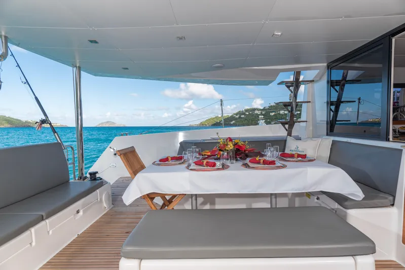 Aquanimity Yacht Photos Pics Luxurious dining setup on 2021 Dufour 48 yacht with ocean view.