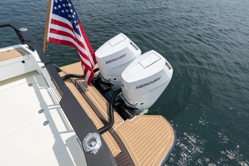 Stock 6 Yacht Photos Pics 2026 Targa 32 GT boat with dual Mercury engines and American flag on water.