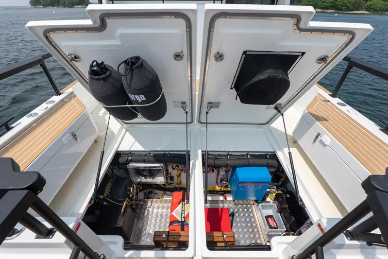 Stock 6 Yacht Photos Pics Open engine compartment of 2026 Targa 32 GT boat, showcasing equipment and storage.