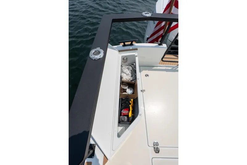 Stock 6 Yacht Photos Pics Storage compartment on 2026 Targa 32 GT boat, open with various items inside.
