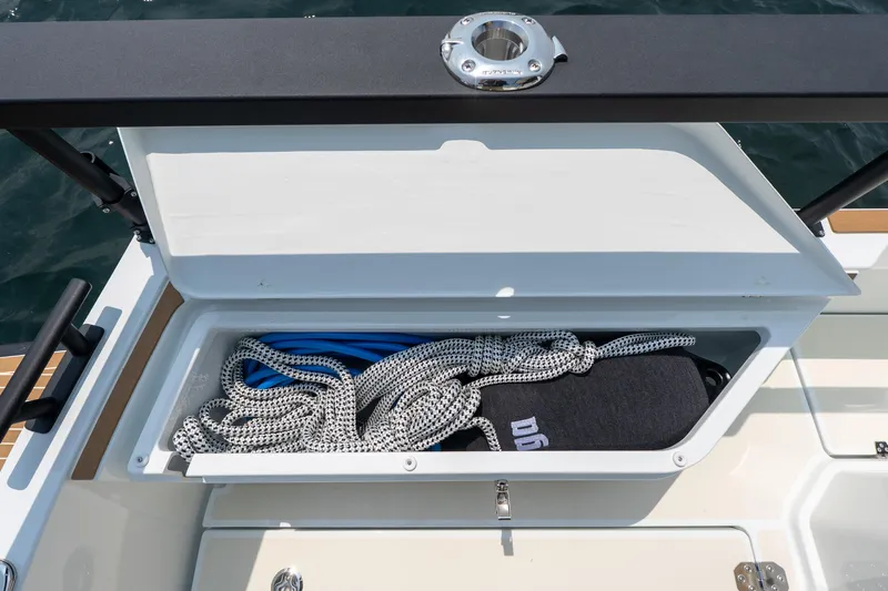 Stock 6 Yacht Photos Pics Open storage compartment on 2026 Targa 32 GT boat, containing ropes and equipment.