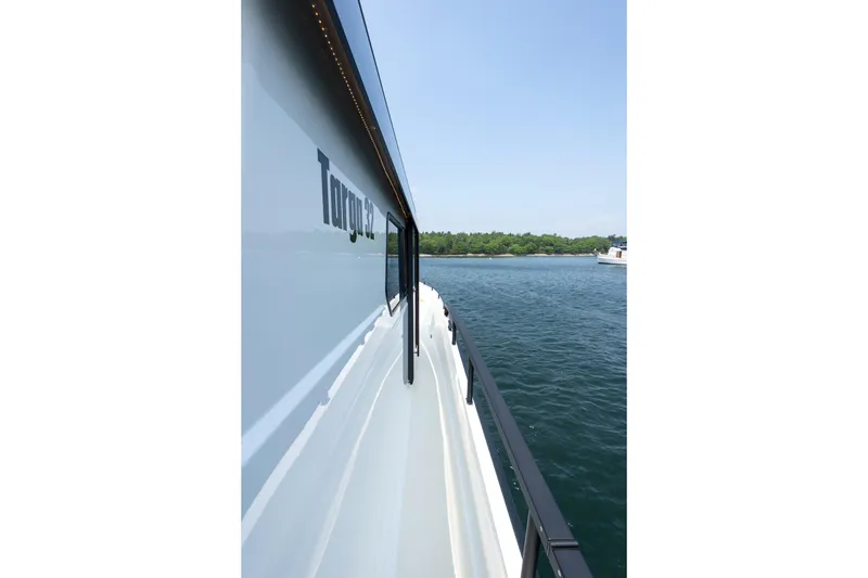 Stock 6 Yacht Photos Pics 2026 Targa 32 GT yacht side view on calm water, clear sky background.